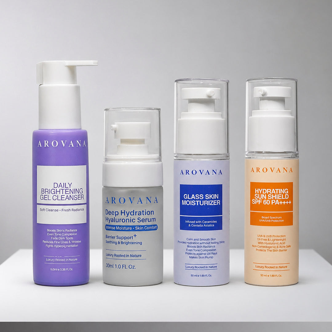 AROVANA Daily Brightening Gel Cleanser in purple, Deep Hydration Hyaluronic Serum in frosted gray, Glass Skin Moisturizer in white with blue label, and Hydrating Sun Shield SPF 50+ in white with orange label.