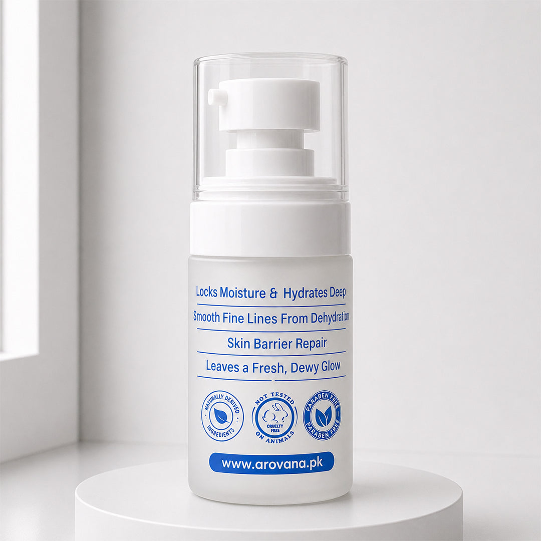A white skincare pump bottle with a clear cap, standing on a white pedestal against a bright, minimalist background. The label features blue text and icons for skin barrier repair and hydration.