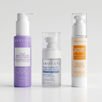 Three AROVANA skincare bottles arranged on a light gray studio background: a lavender Daily Brightening Gel Cleanser bottle on the left, a clear-topped Deep Hydration Hyaluronic Serum bottle in the center, and a white Hydrating Sun Shield SPF 60 PA++++ bottle on the right.
